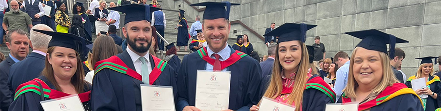 Cansfield High School teachers at Graduation banner